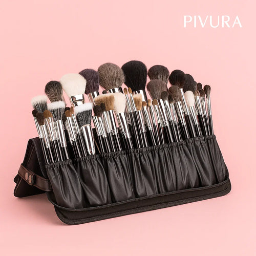 Set of makeup brushes in a black holder with PIVURA branding on a pink background