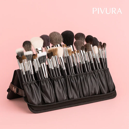 Set of makeup brushes in a black holder with PIVURA branding on a pink background