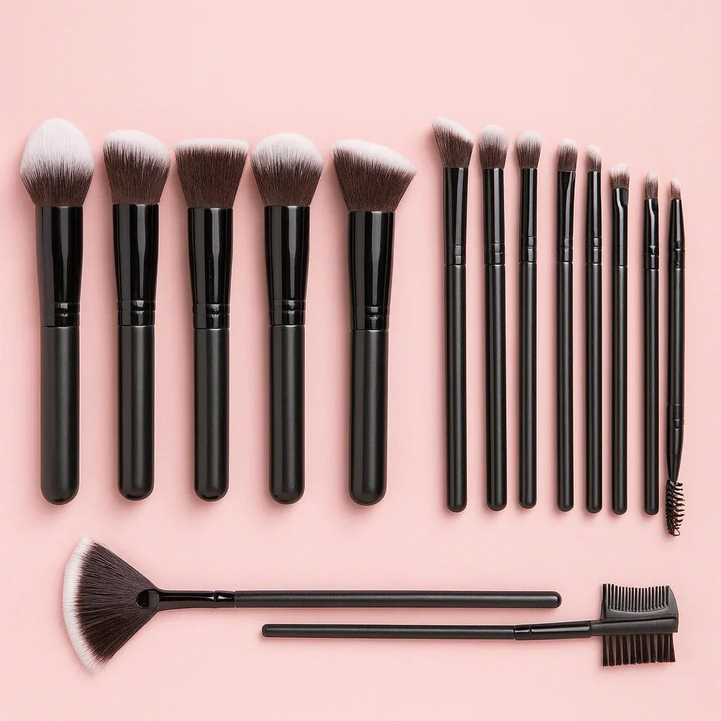 Makeup brush set with black handles on pink background, beauty tools flat lay