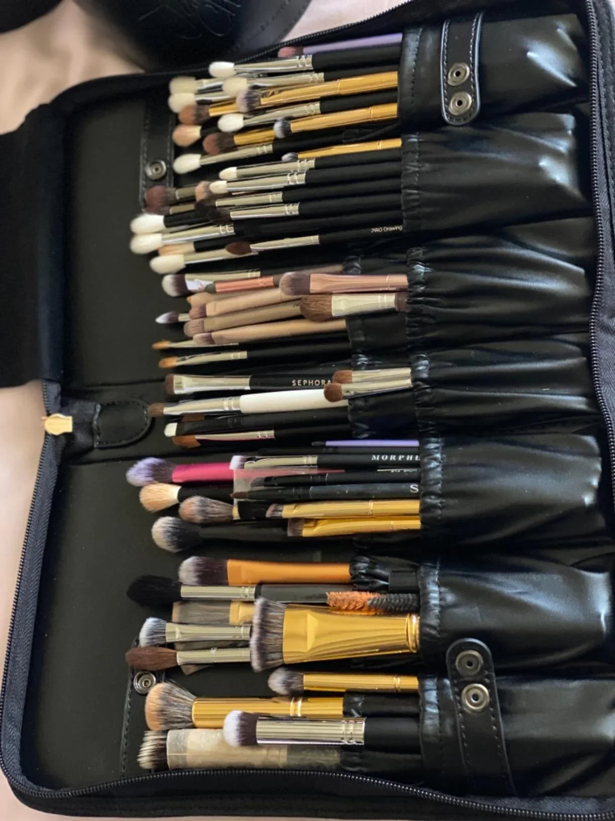Set of makeup brushes in a black leather case